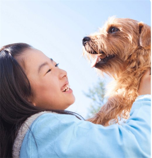 愛犬と屋外で笑顔の女の子